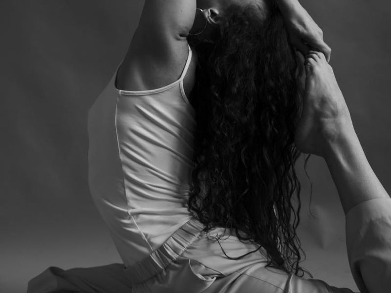 A person in a fluid yoga pose, showing control and balance.